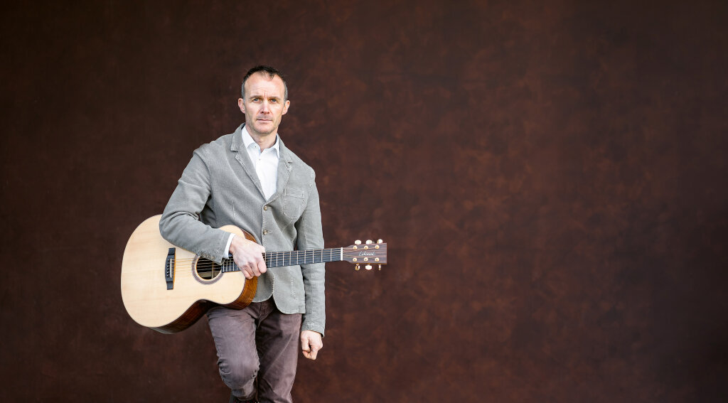 Der Liedermacher Norbert Nössing mit seiner Gitarre: „Ich war ein richtiger Heimplärrer.“ Foto: Philipp Santifaller